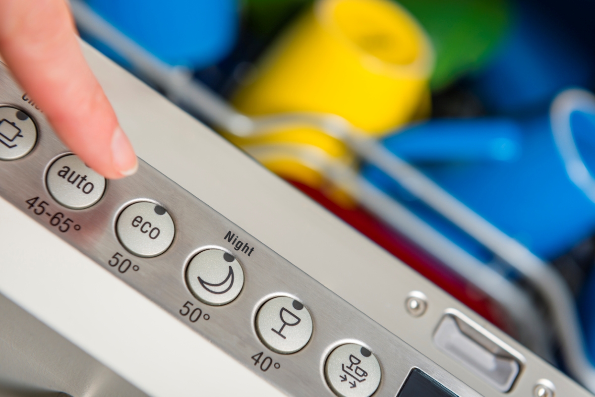 ways to save money at home - pressing dishwasher button