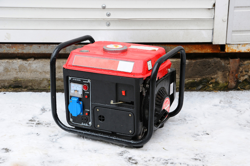 portable electric generator outdoors in the snow