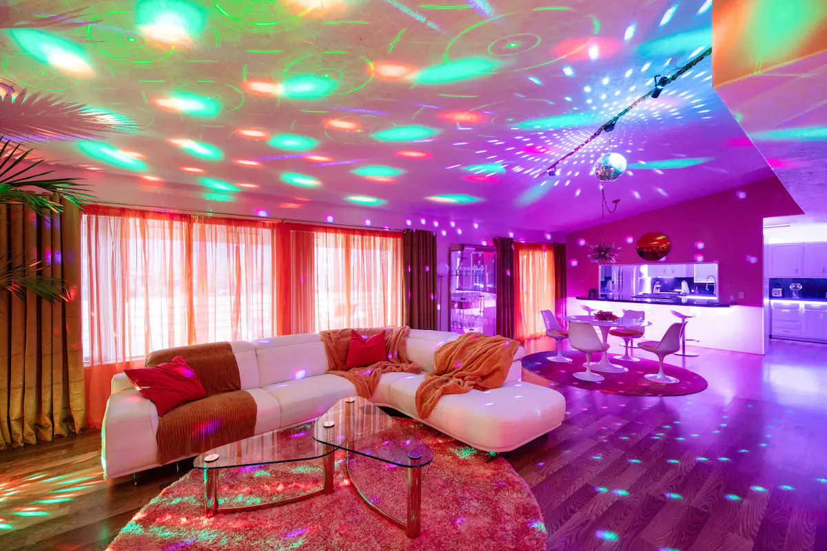 Airbnb-themed-short-term-rental-disco-house-living-and-dining-room-with-colored-lights
