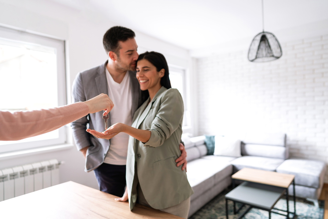 iStock-1285513082 over improve home couple receiving keys to apartment