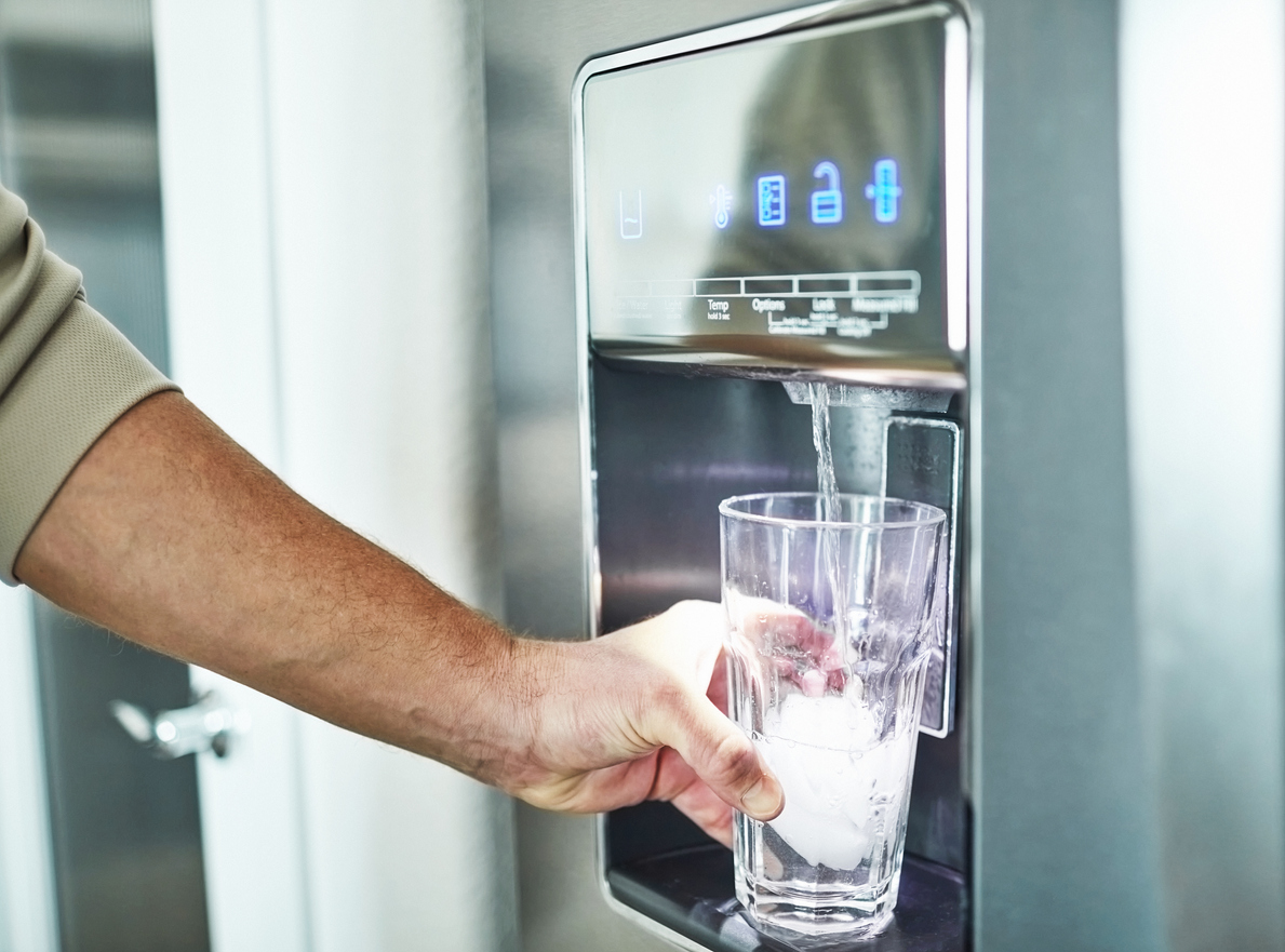 iStock-1300229763 real estate agent dont want man filling glass from refrigerator water dispenser