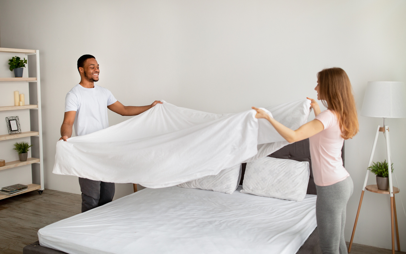 iStock-1315158206 must do february projects couple making the bed.jpg