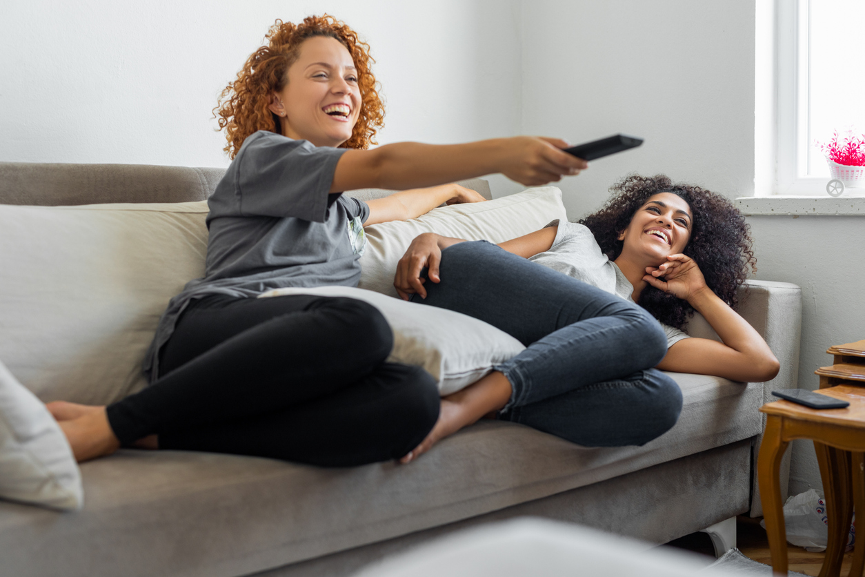 iStock-1350071405 productivity hacks two women watching TV on the couch