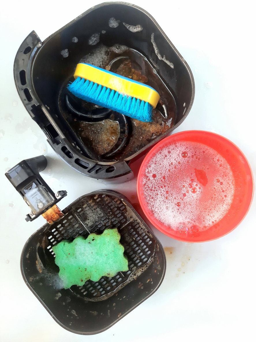 iStock-1366704819 how to clean an air fryer cleaning an air fryer with sponge and soap.jpg