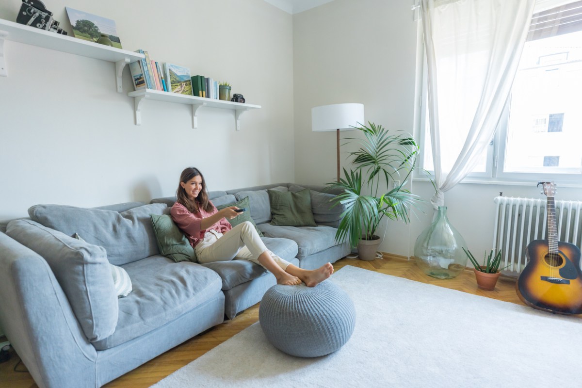 iStock-1425696111 get the funk out of rugs and curtains woman sitting in living room.jpg