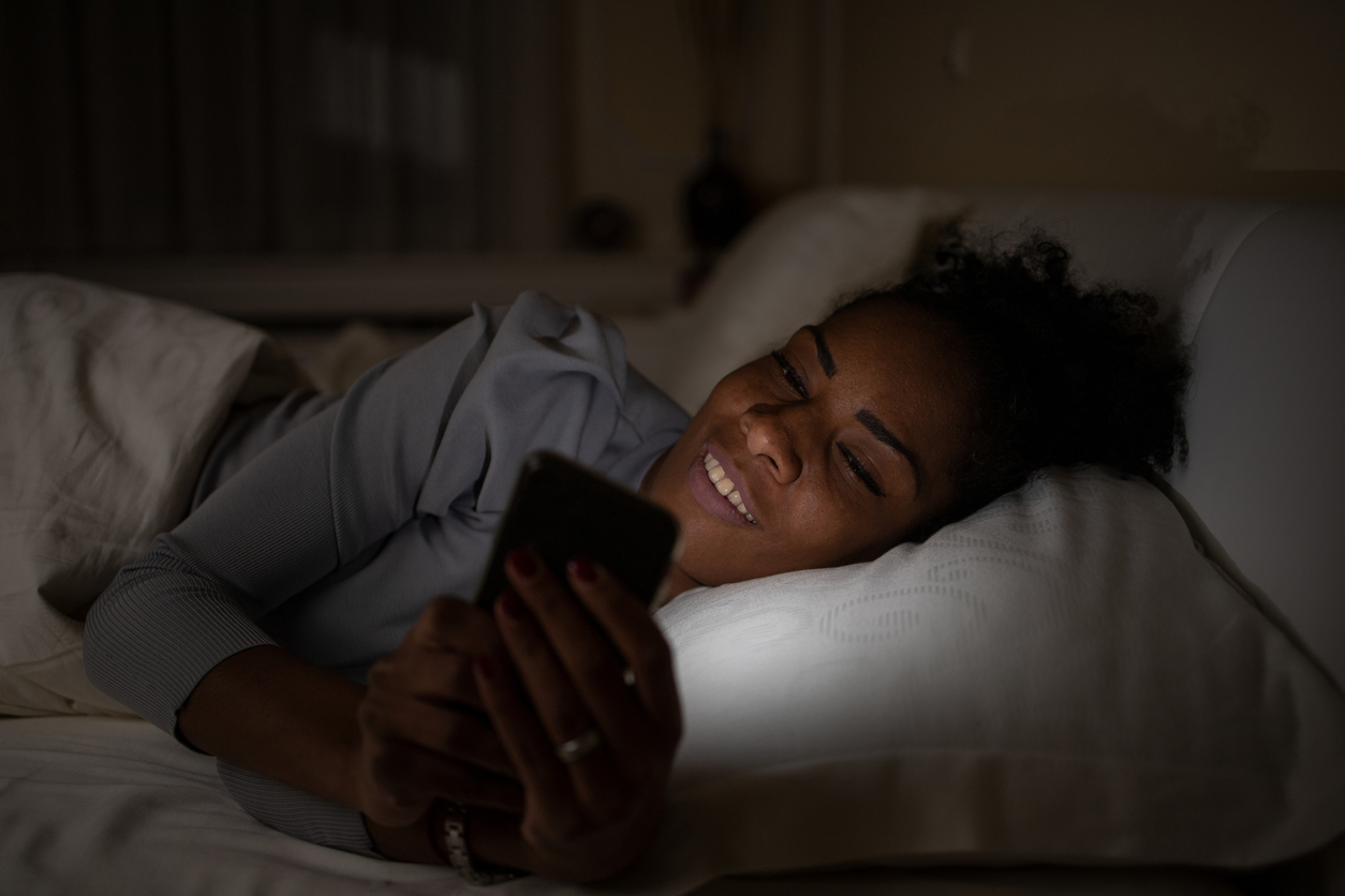 iStock-1444820151 ways to improve your life young woman using cell phone in bed