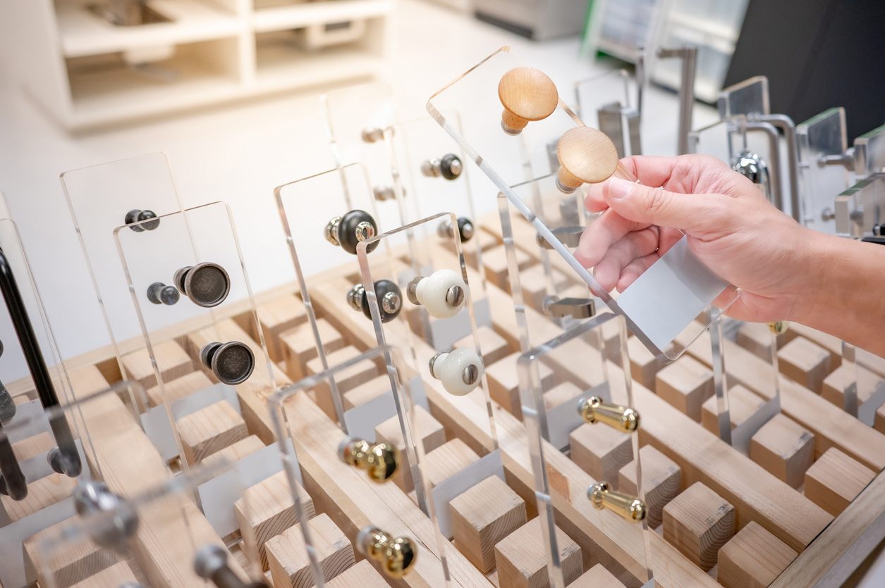 iStock-1455765572 Home Depot Shopping Male hand choosing cabinet door knob