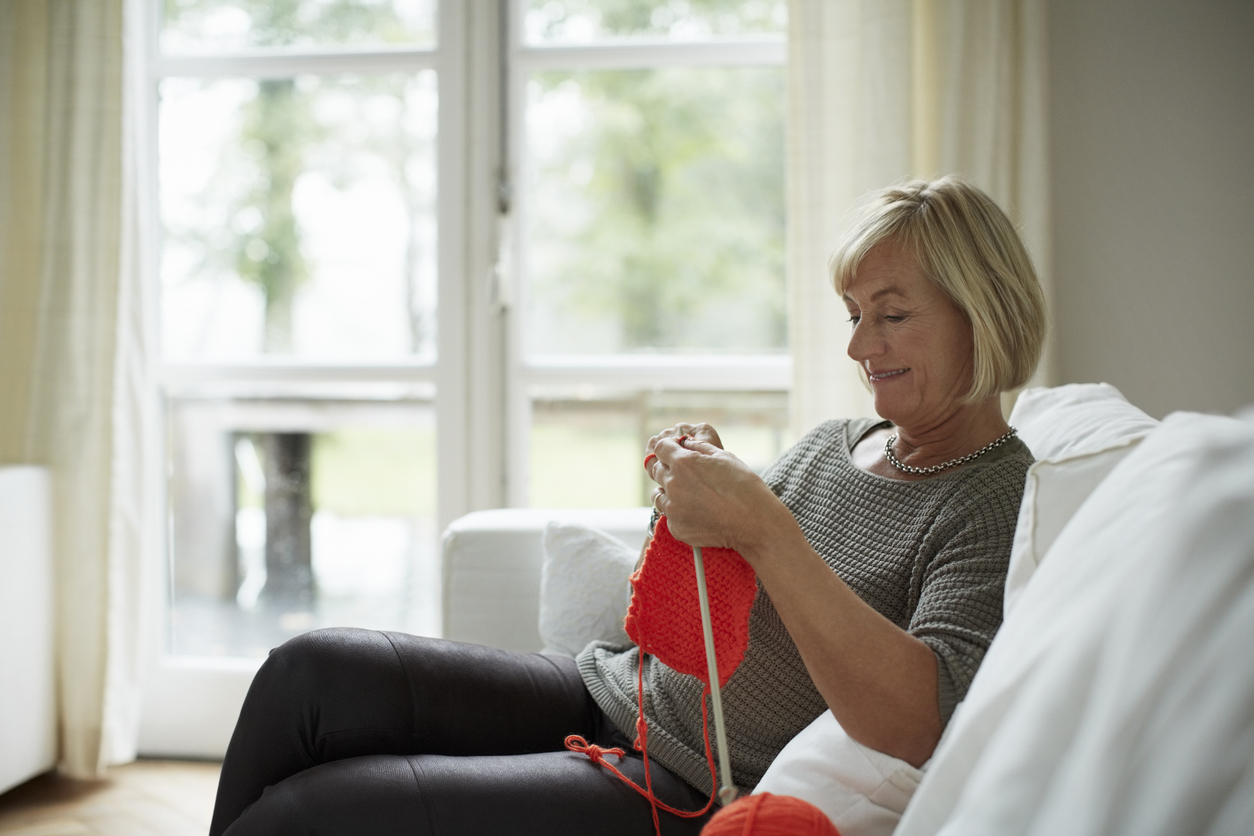 iStock-499550653 volunteer opportunities older woman knitting on couch