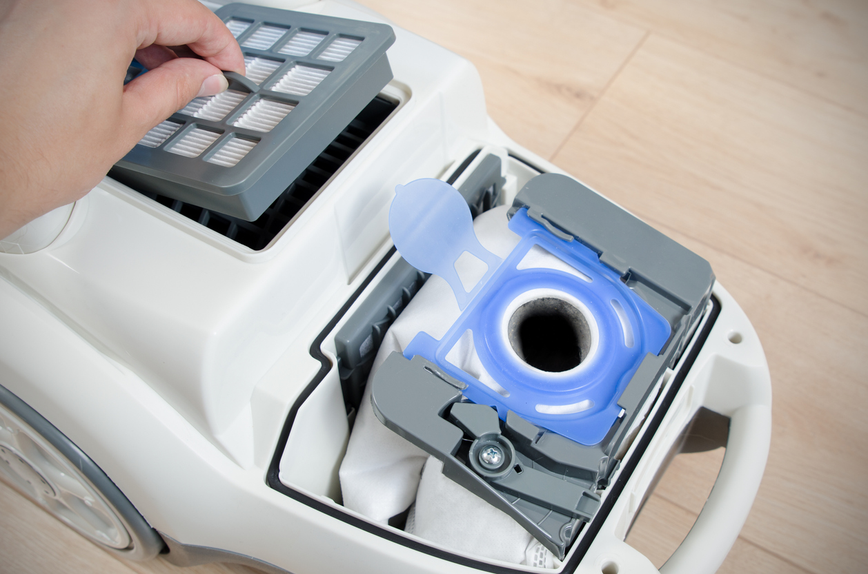 Replacing the air filter in a vacuum cleaner.