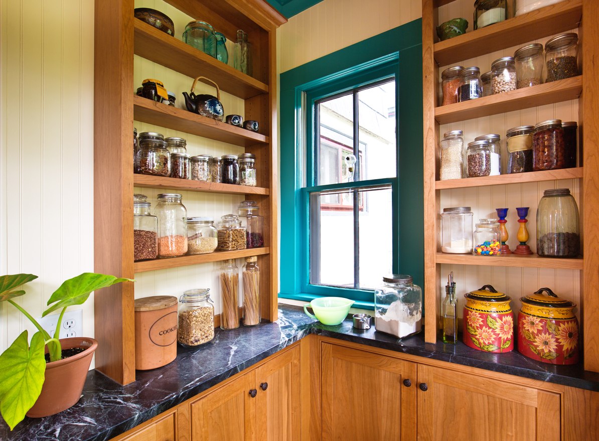 A traditional kitchen featuring a pantry storage shelf and maple cabinet