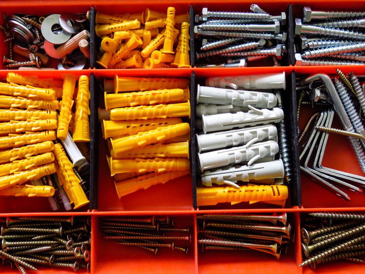 Expanding drywall anchors, screw, and bolts of various sizes in a toolbox