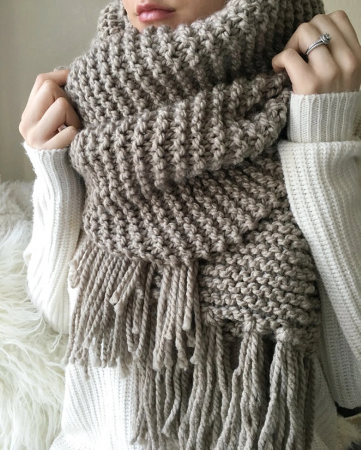 knitting patterns for beginners - woman wearing tan knitted scarf