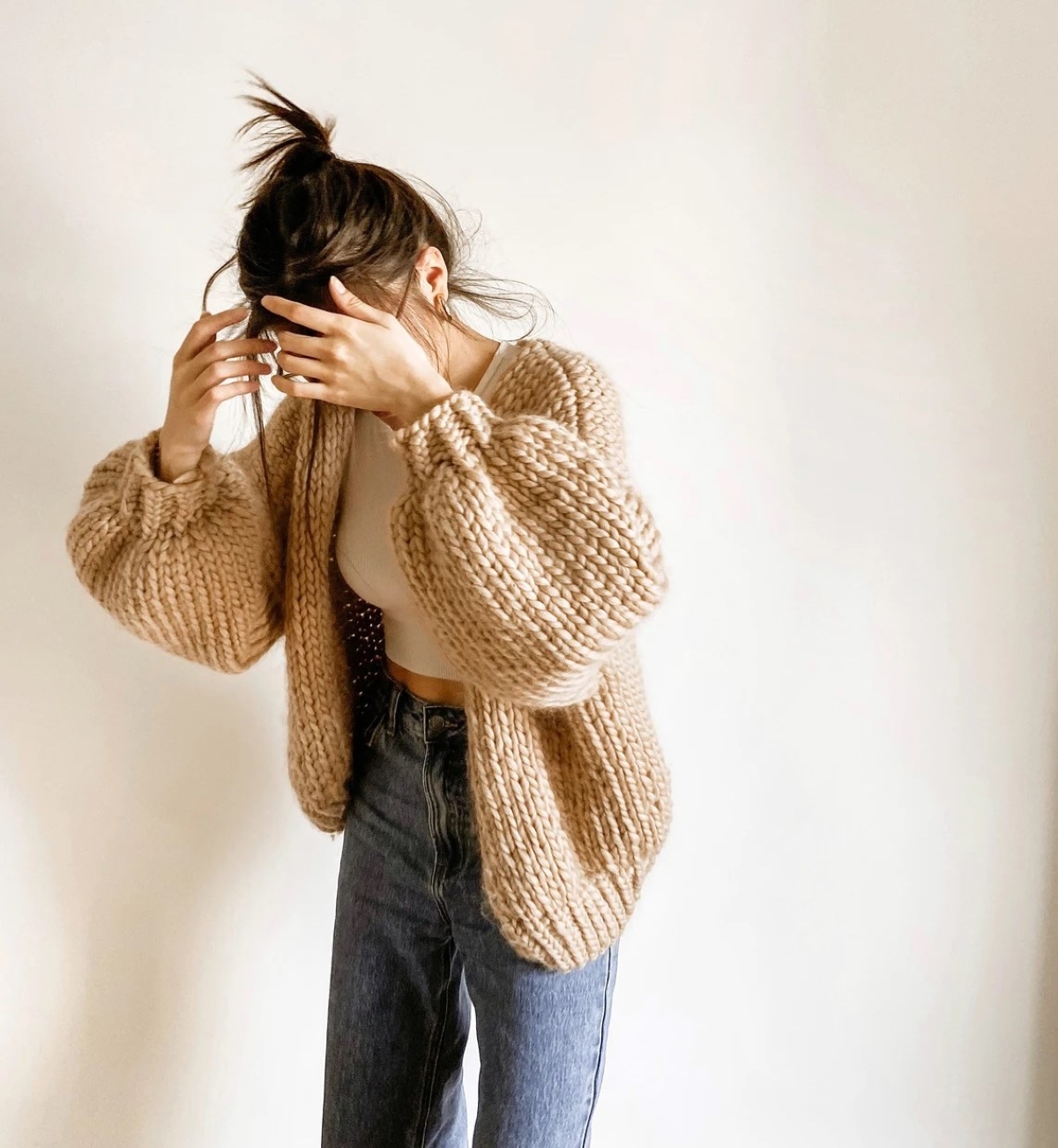 knitting patterns for beginners - woman wearing tan oversized cardigan