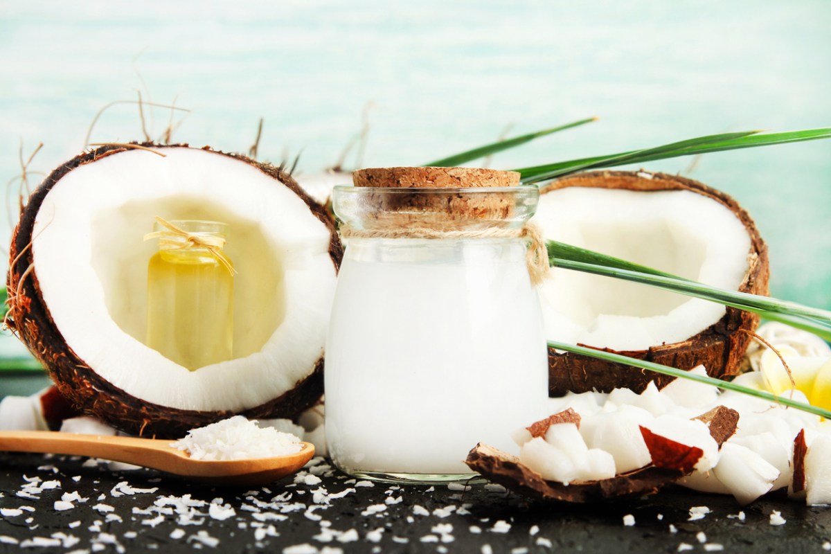 coconut oil uses jar of coconut oil with coconut halves and coconut pieces decorative display