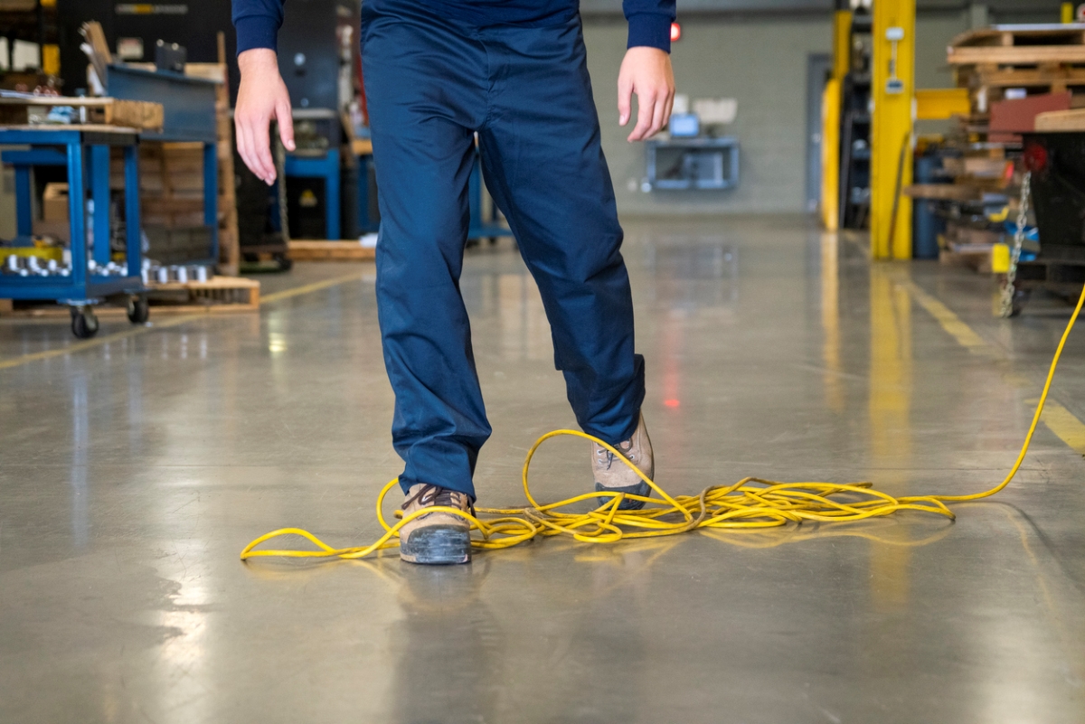 most dangerous power tools - person stepping in yellow extension cords