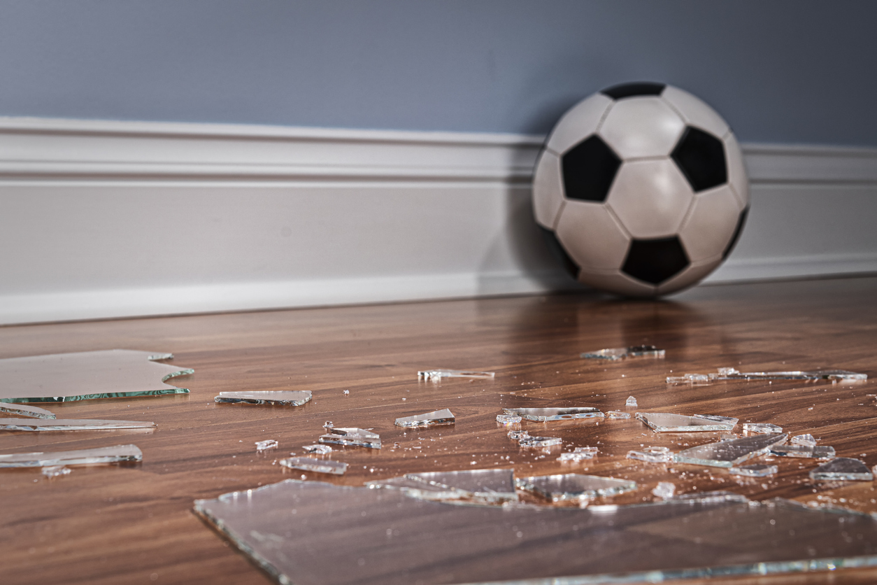 security window film soccer ball on wood floor with broken glass window breaking