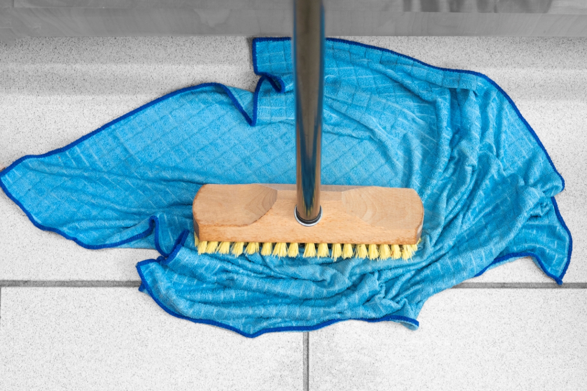 ways to clean behind and under every appliance - broom on blue microfiber cloth
