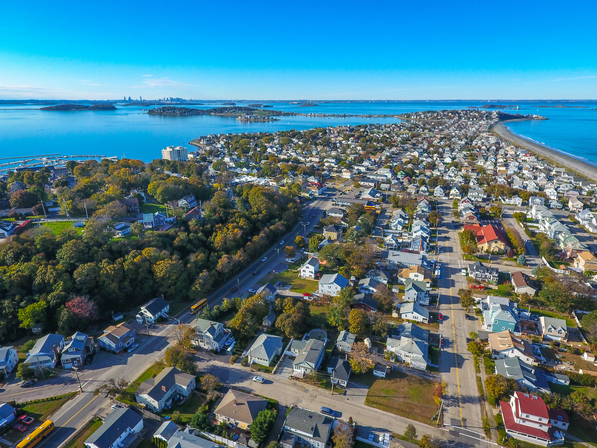 iStock-1256776064 5 Places in the U.S. Where Homes Are Almost Uninsurable Because of Hurricanes and Flooding Hull MA with boston in distance