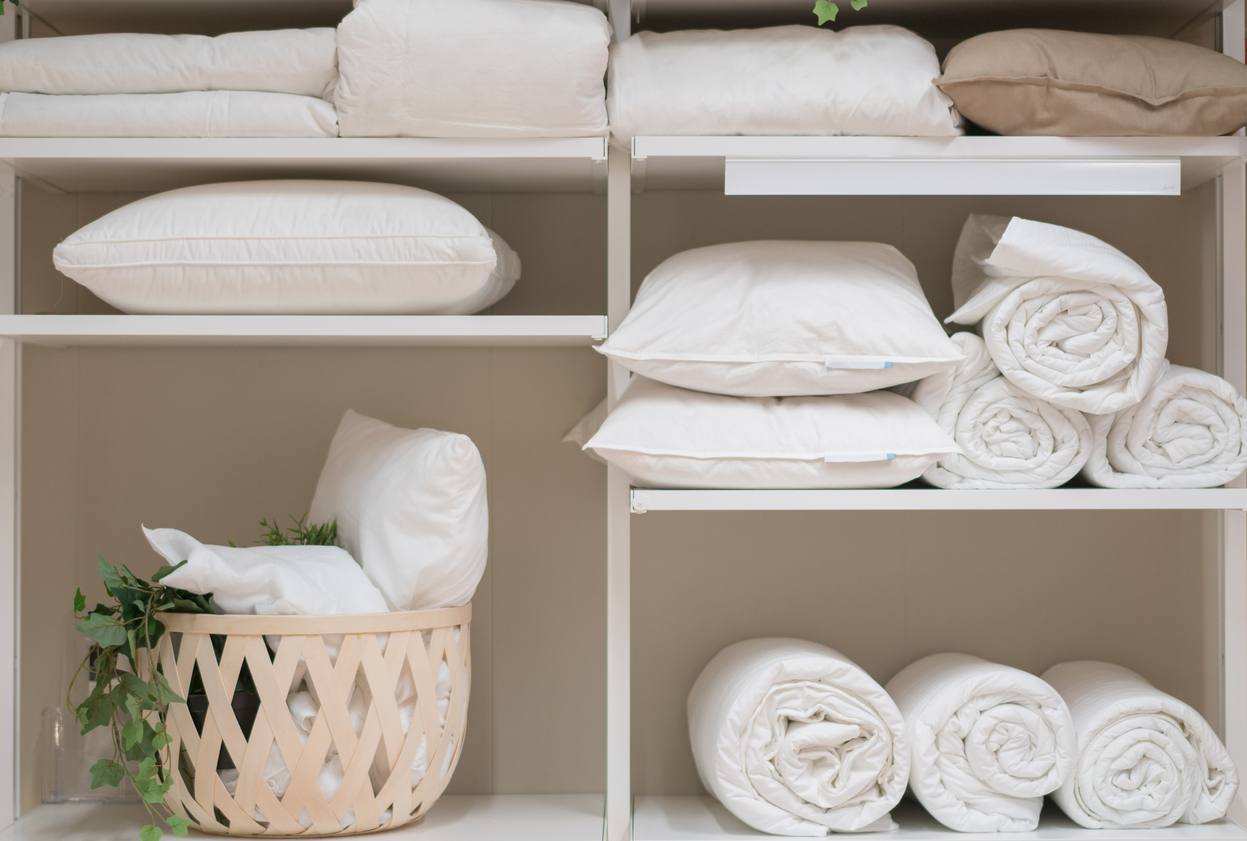 14 things you didn't know you can clean in your washing machine pillows on shelves with towels clean laundry