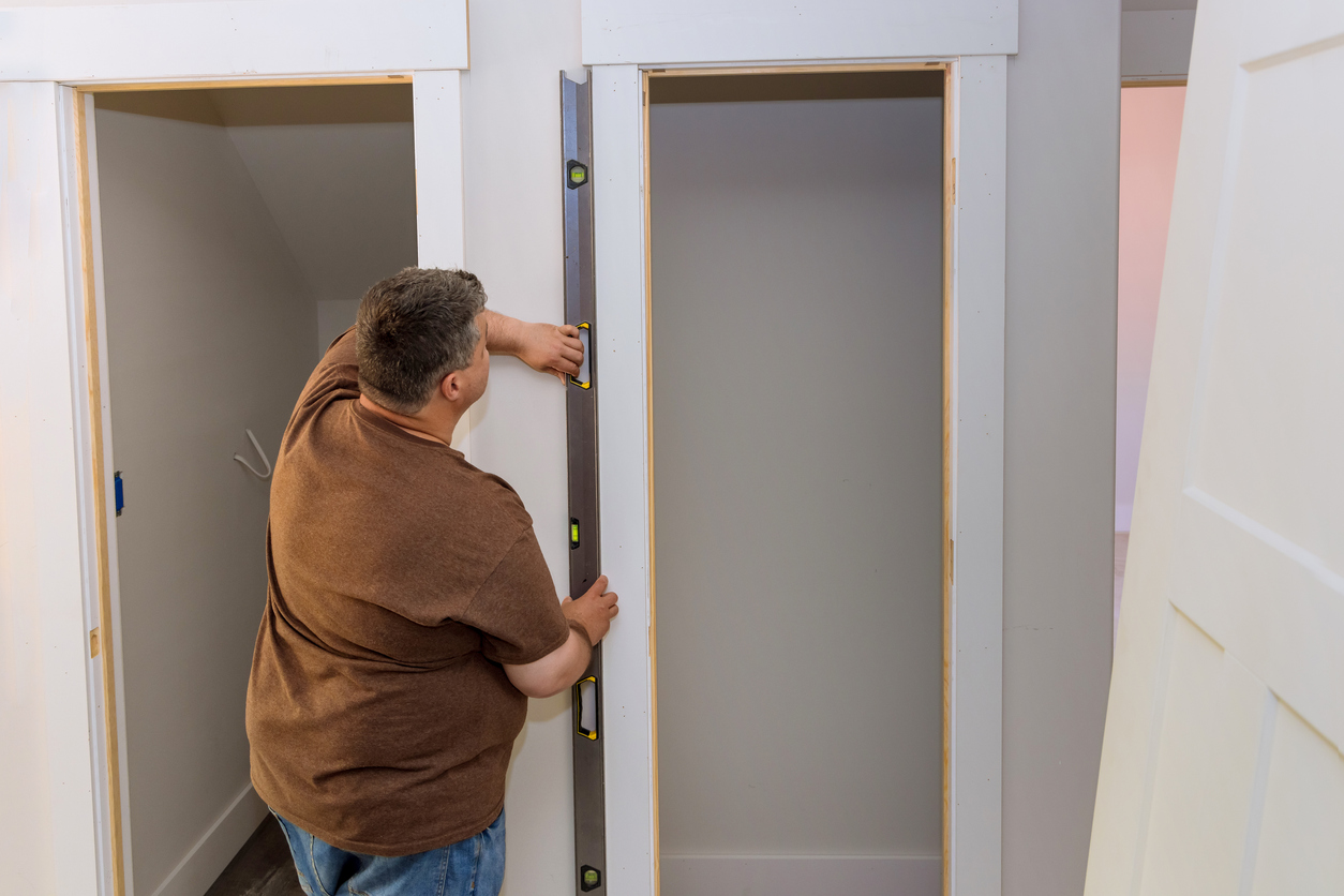 iStock-1398012700 walk-in closet storage space evaluating wall between two closets