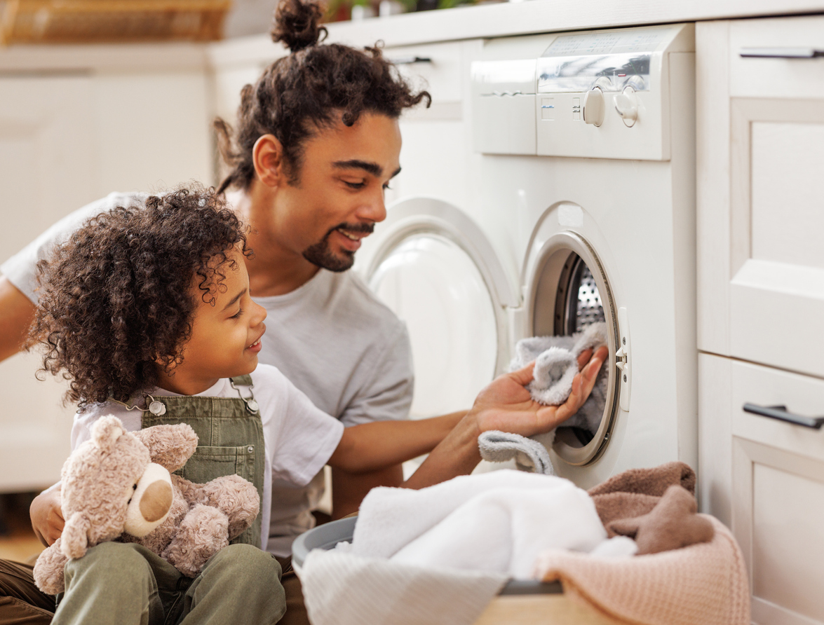 14 things you didn't know you can clean in your washing machine father and son doing laundry together