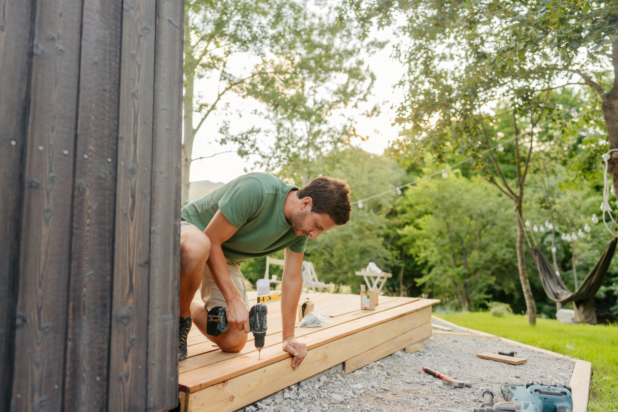 iStock-1429454751 tax return home improvements man buildling deck in backyard