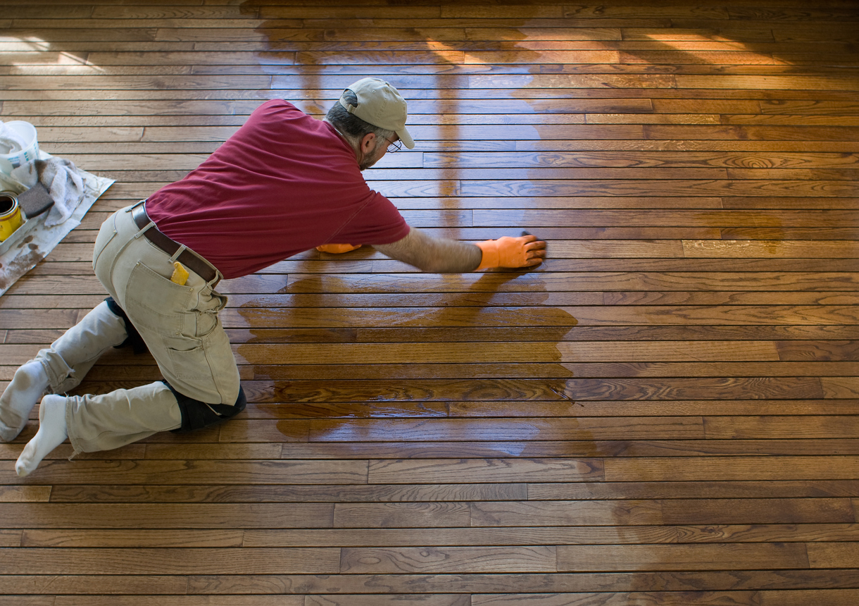 iStock-172925427 tax refund home improvements man refinishing hardwood floors