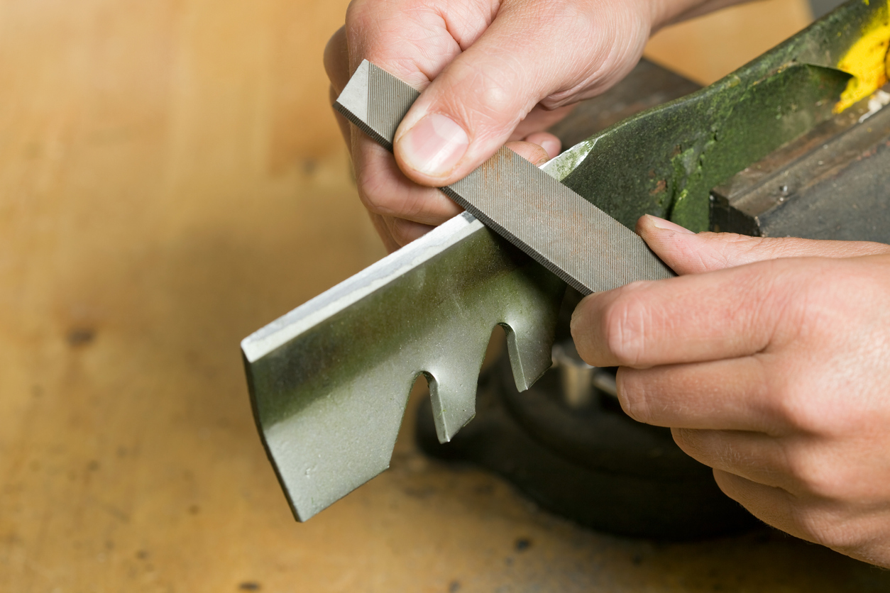 iStock-184603665 must dos march Lawnmower Blade Sharpening with File