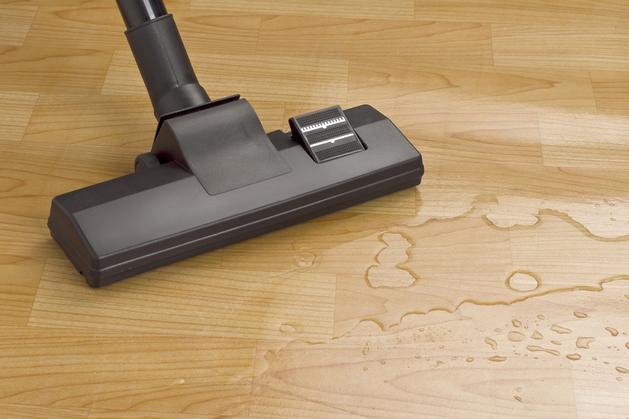 9 things you should never vacuum black vacuum near puddle of water on wood floor