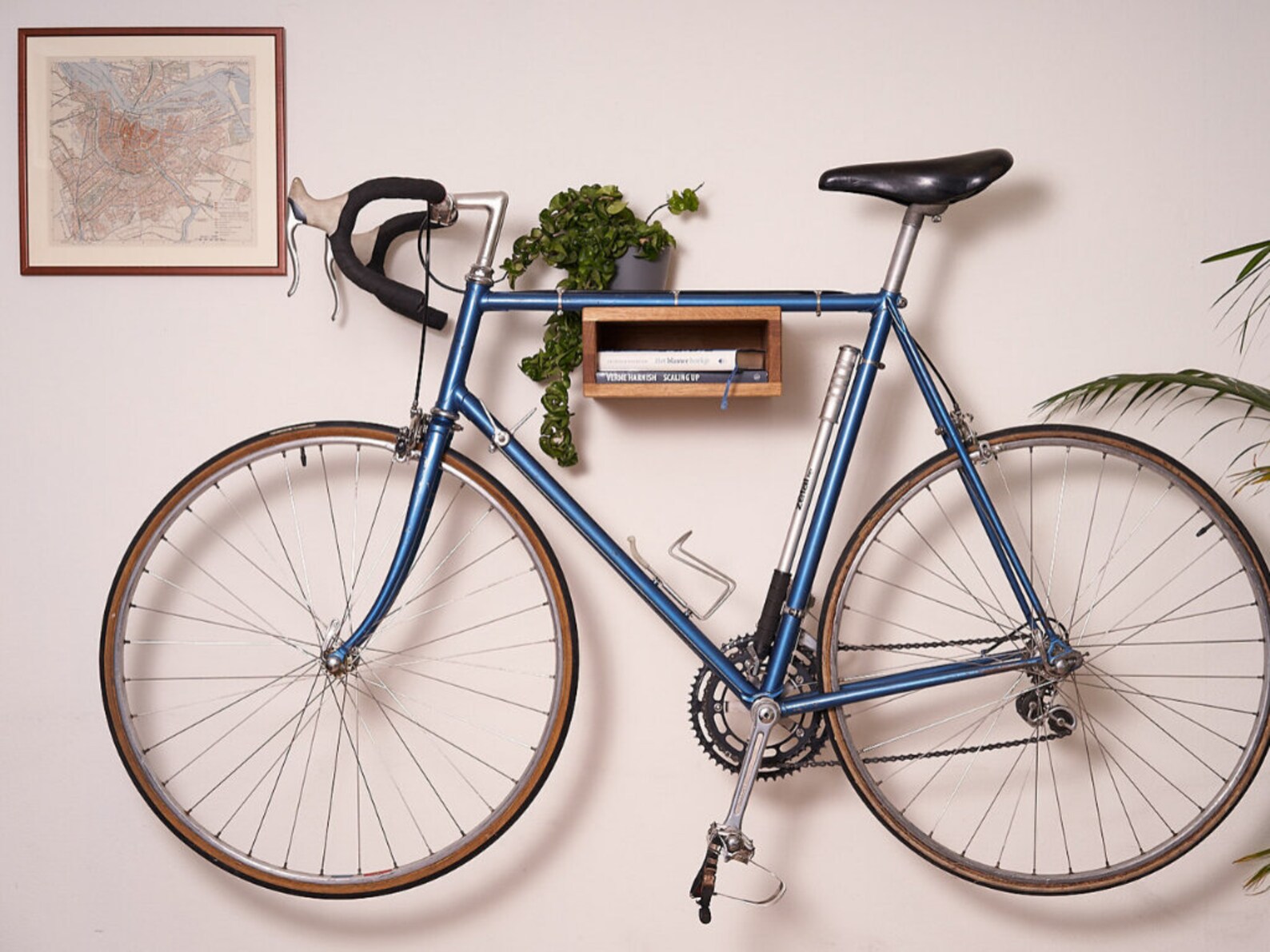 Etsy Wall Decor Ideas Wooden Bike Rack with Flowers on Top doubling as bookshelf