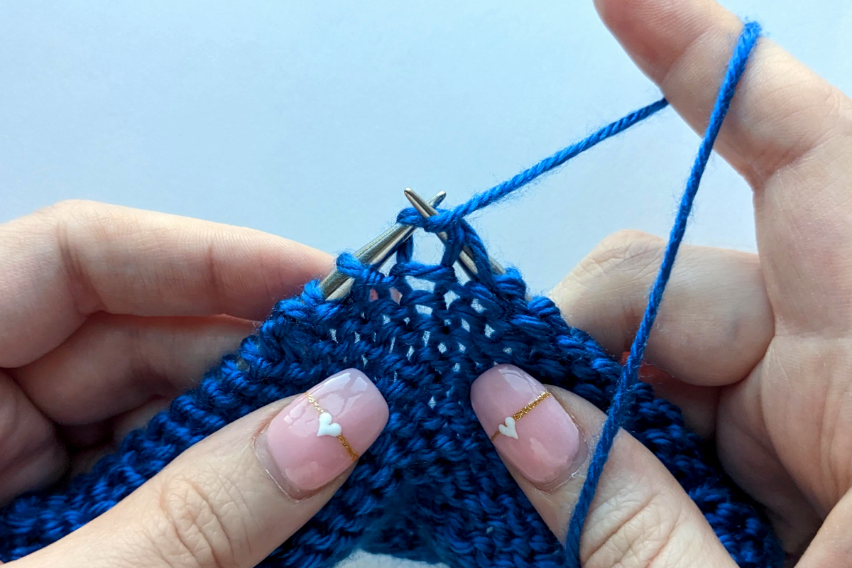 Purl stitch in knitting demonstrated up close