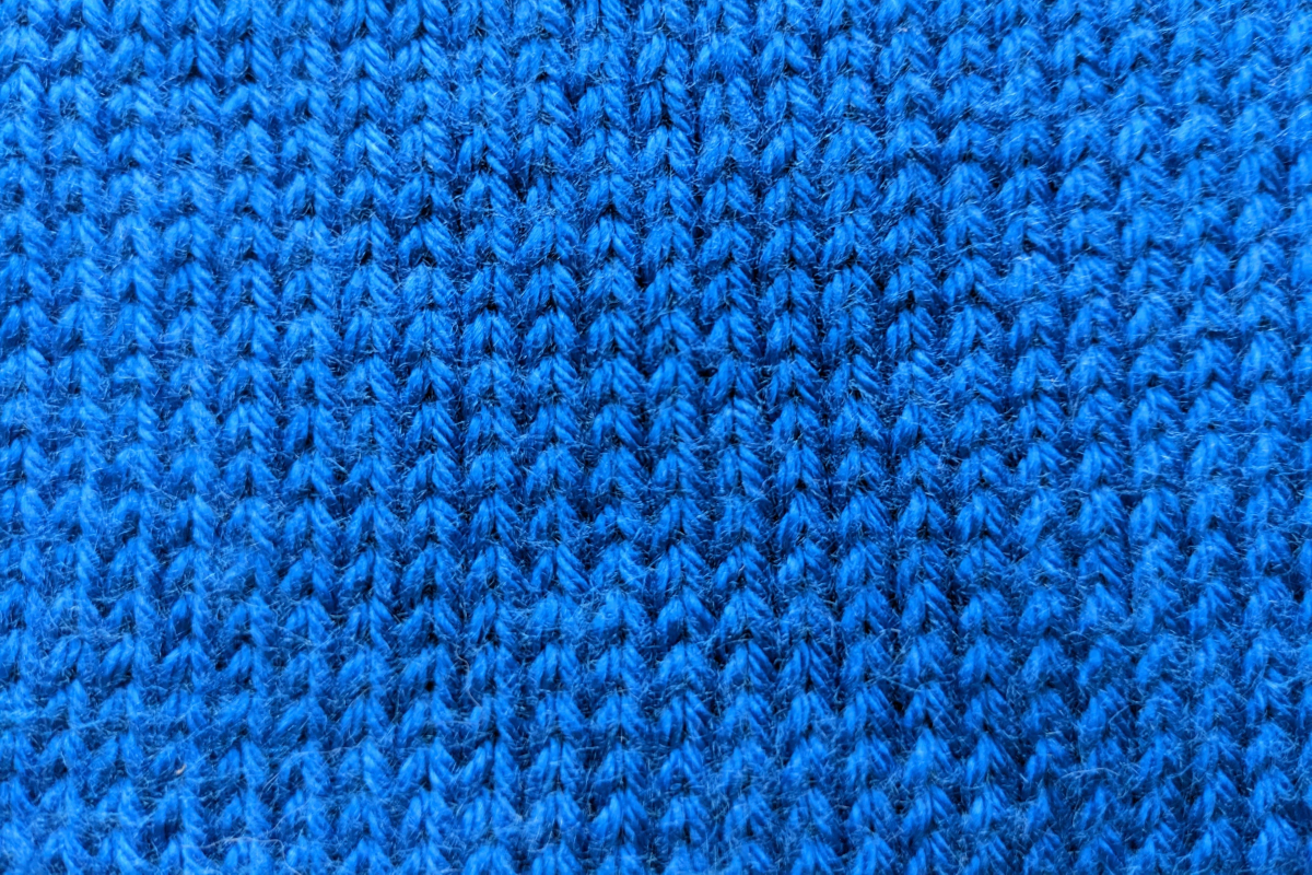Closeup of stockinette stitch made with blue medium-weight yarn