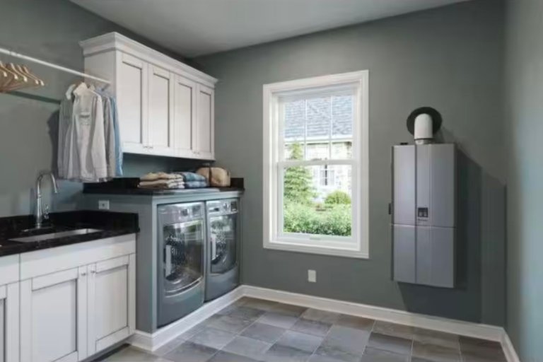 A water heater from the best water heater brands mounted on a laundry room wall