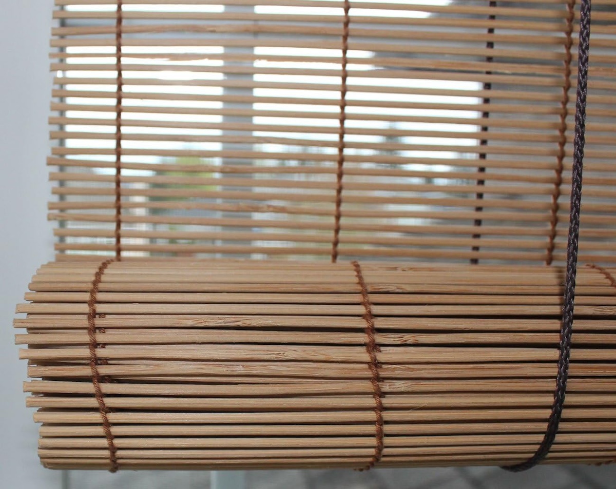 A close-up image of match stick blinds on an interior window. 