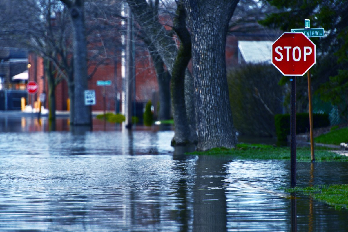 flooded residential street with stop sign