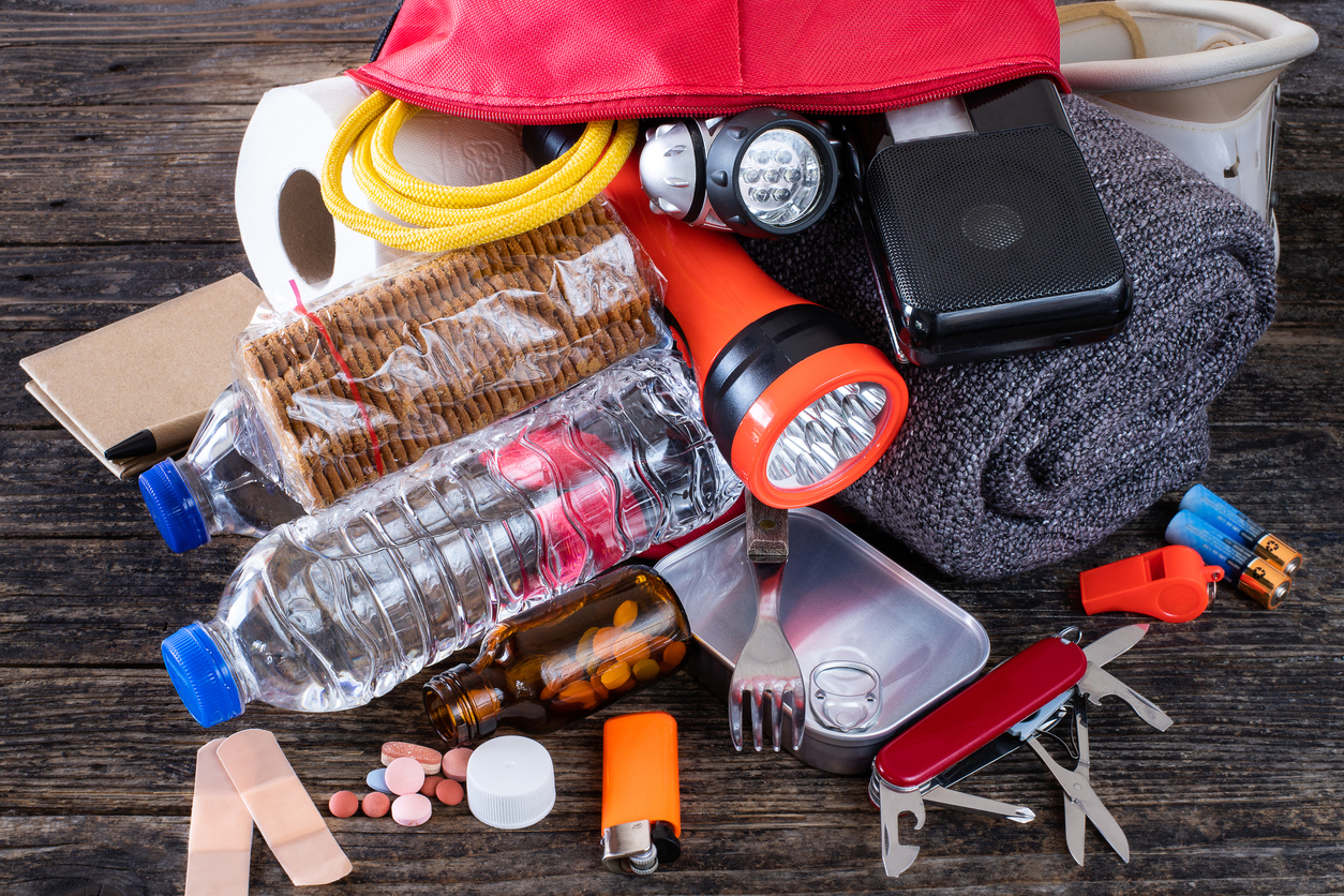 "go bag" of emergency essentials, including flashlight and water