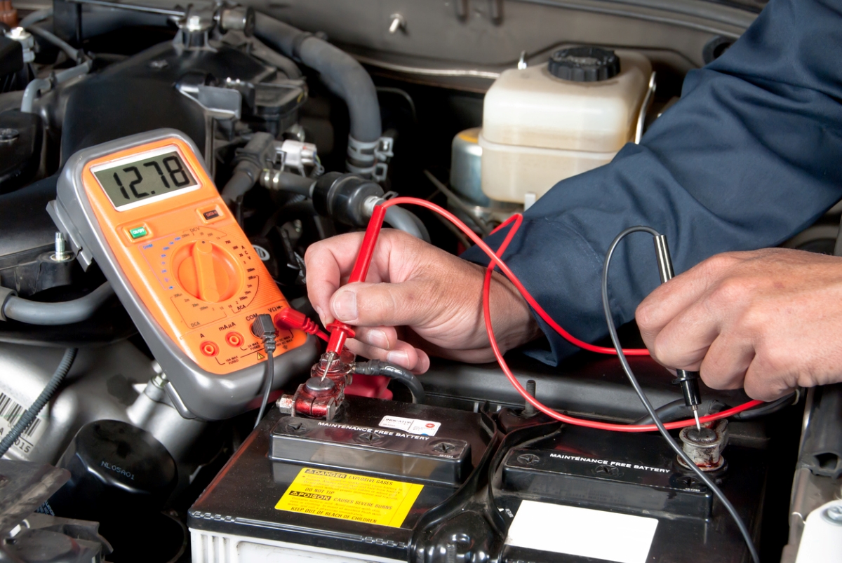 car maintenance tasks - hands checking car battery