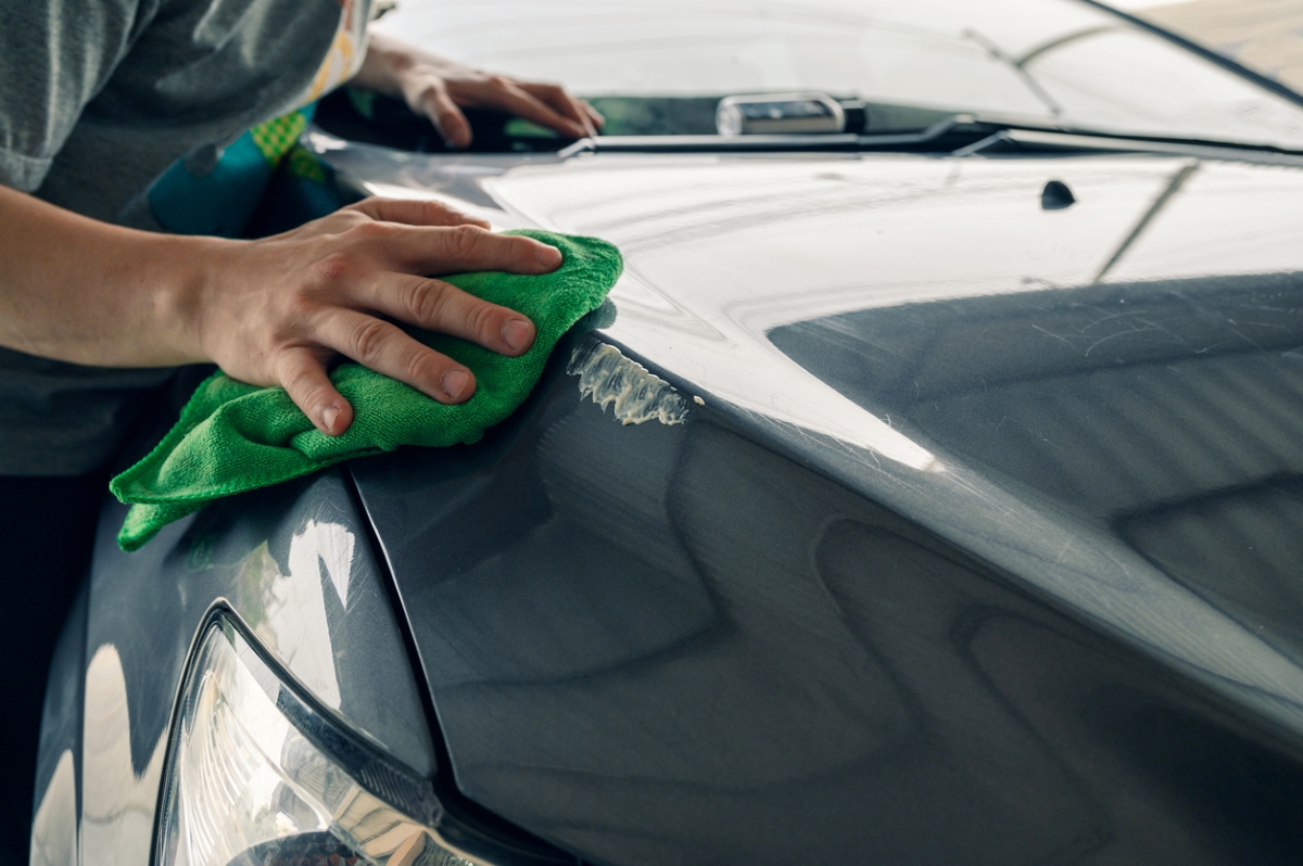 car maintenance tasks - man waxing car