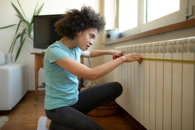 bob-vila-editors-projects-2023-woman-measurng-wall-for-project