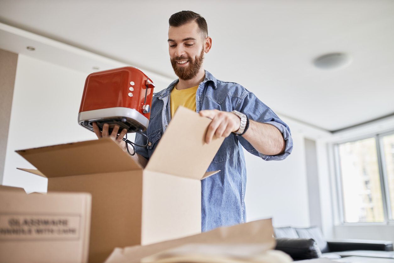 iStock-1315031105 alternatives to craigslist Man, owner of small business packing product in boxes, preparing it for delivery