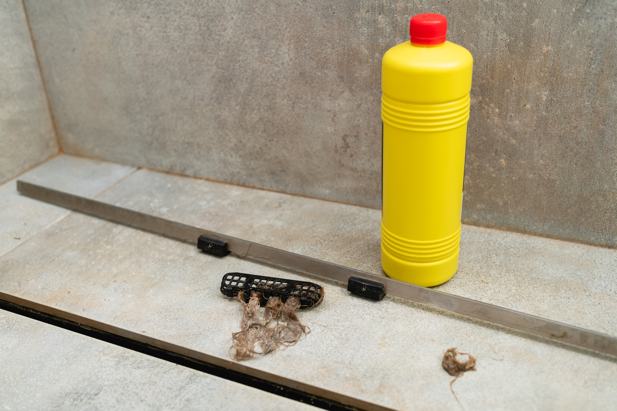 iStock-1429696283 how to unclog a drain Liquid cleaner in a yellow bottle for cleaning sewer drains