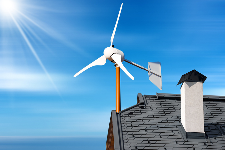 energy-efficient-tax-credit-wind-turbine-on-house-roof-with-blue-sky-and-sun