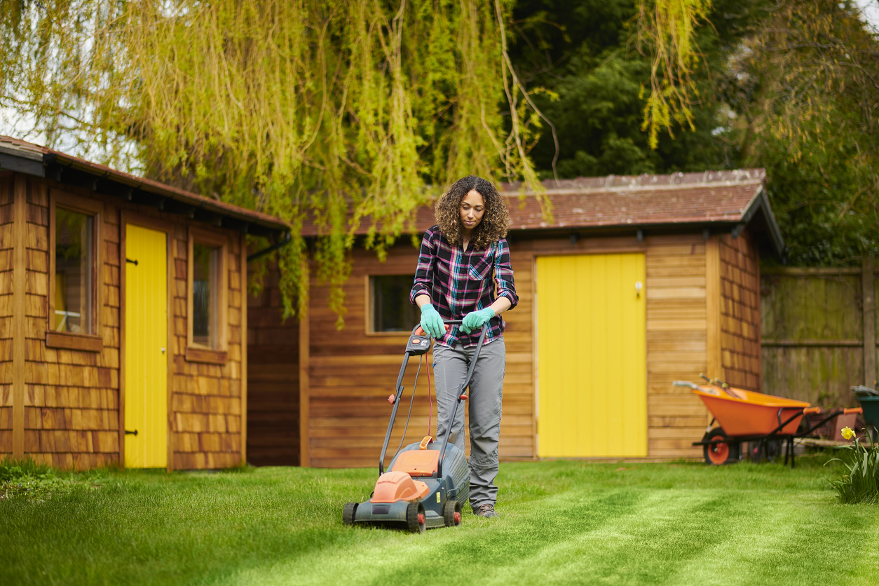 mowing mistakes everyone makes woman mowing lawn in vertical lines
