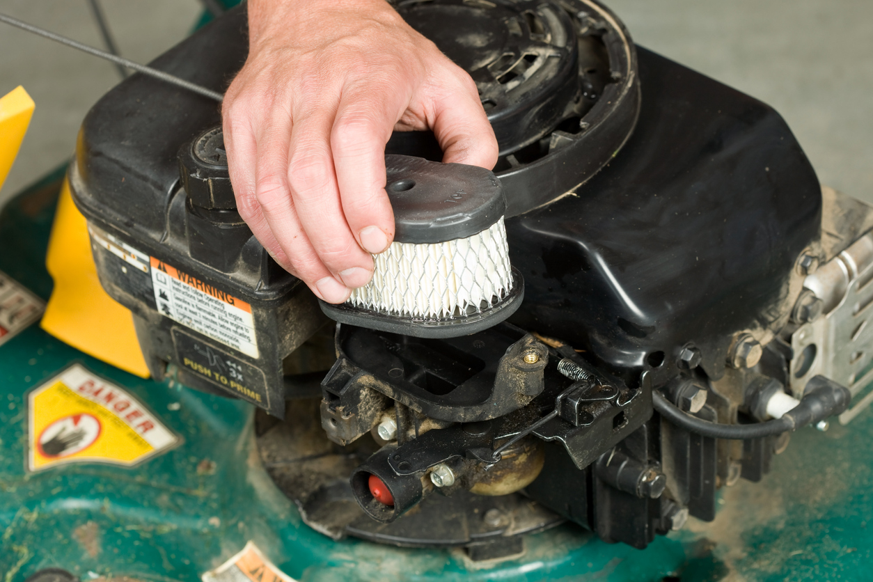 mowing mistakes everyone makes man replacing lawnmower filter