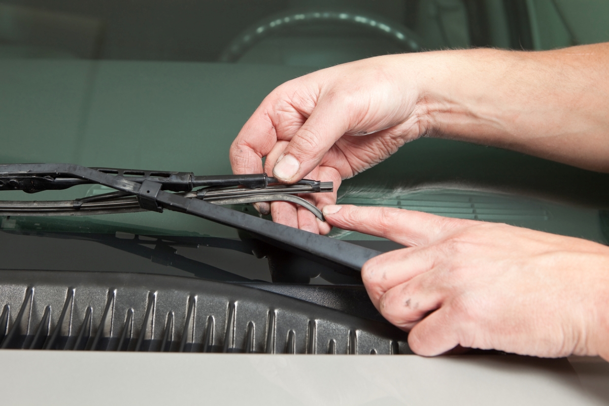 car maintenance tasks - hands checking broken windshield wiper