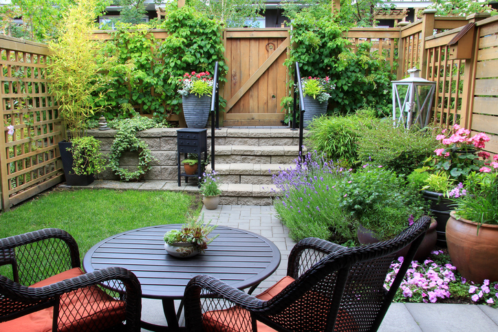 pocket-garden-with-flowering-plants-and-black-rattan-sitting-area