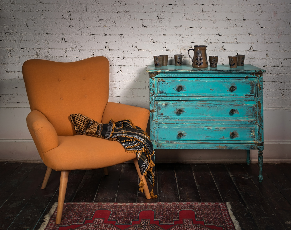 iStock-518729710 alternatives to craigslist Vintage orange armchair, blue cabinet and ornate scarf