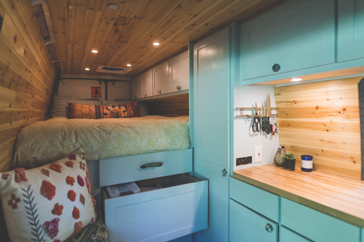 camper-decor-blue-painted-kitchen-cabinets-and-bed-camper