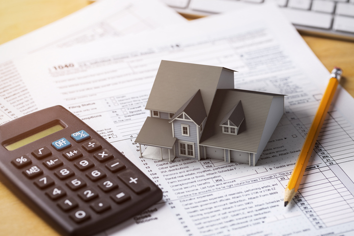 energy-efficient-home-tax-credits-calculator-and-pencil-and-small-house-on-tax-forms
