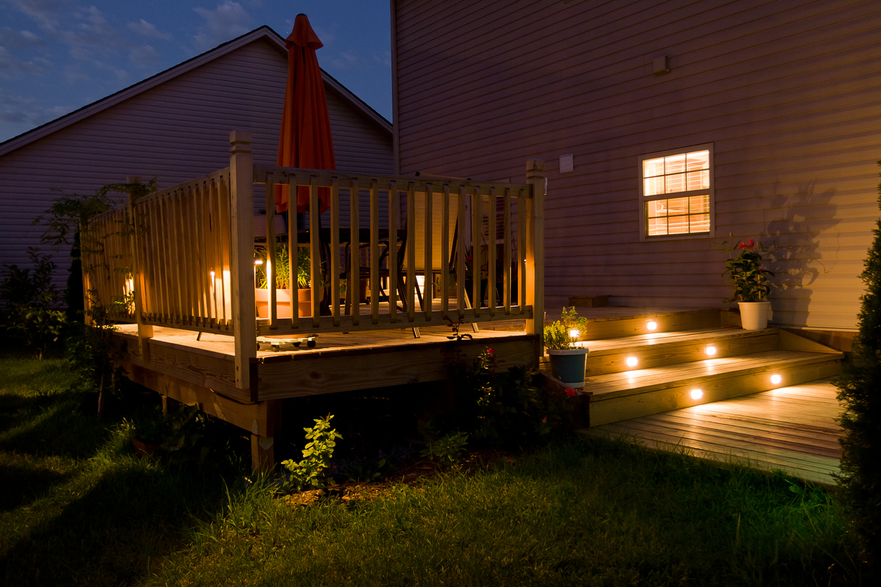 iStock-912332776 uplighting techniques Wooden deck and patio of family home at night